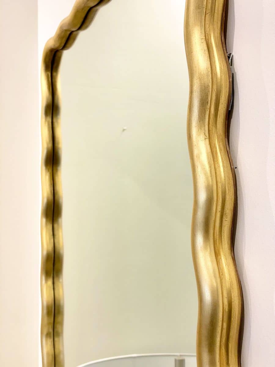 Large gold scalloped mirror with antique design, ornate detailing, and undulating moulding.