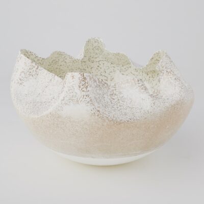 Close-up of a large ivory ruffled edge bowl, handcrafted with variations in color and shape.