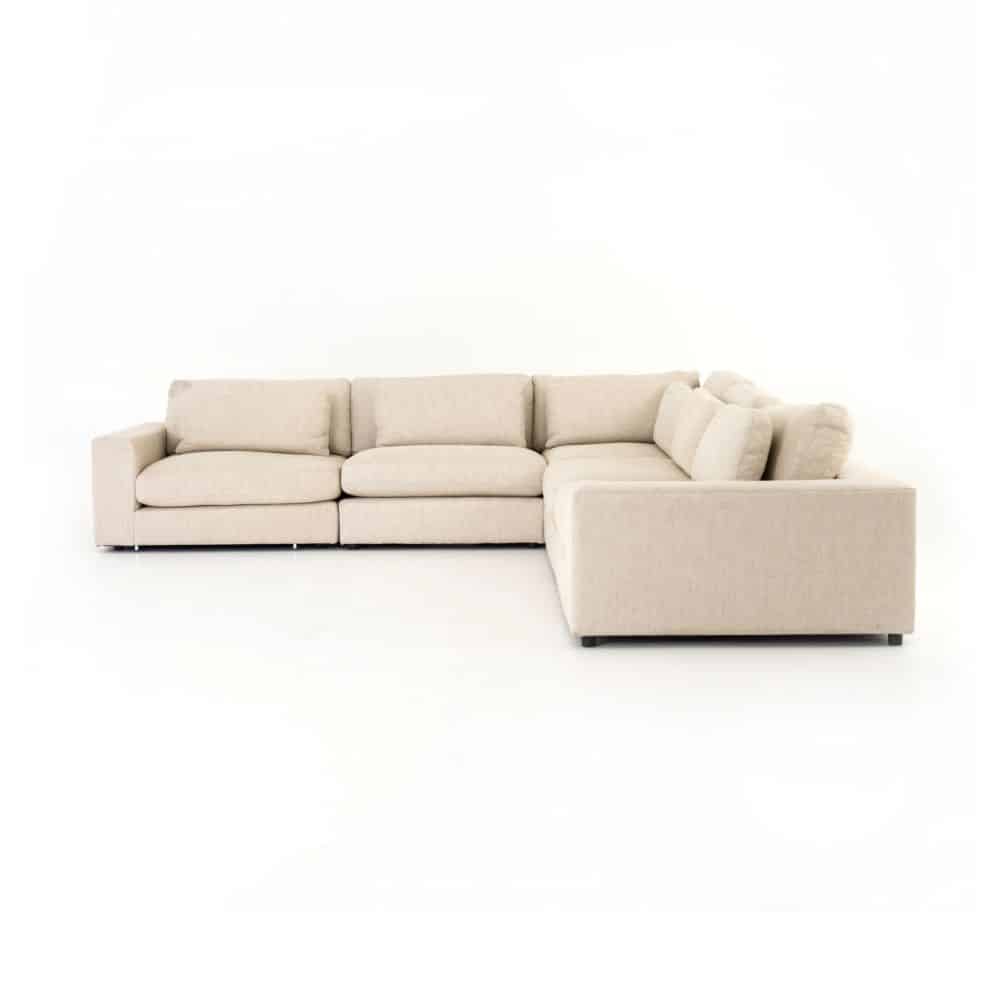Long, L-shaped sectional sofa with neutral color upholstery and multiple cushioned seating options.