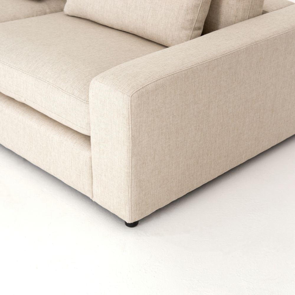 Close-up view of the Blaine 5 Piece Sectional Sofa, showcasing its natural fabric and feather fiber blend cushions.