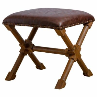 Antique-style wooden bench with brown leather upholstery and brass tack trim, set against a white background.