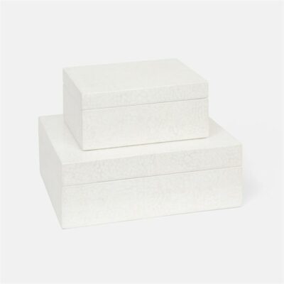 A collection of three stacked square gift boxes in a neutral color each with a crackled lacquered finish and a glossy texture