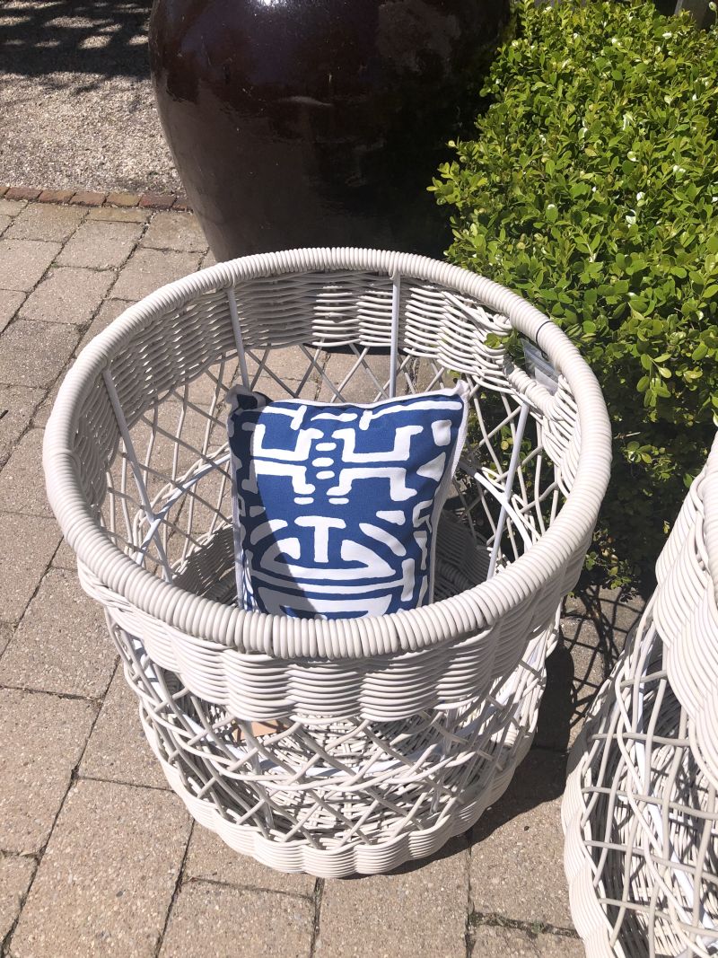 Large outdoor wicker basket on porch.
