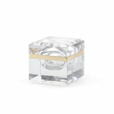A clear, thick cast glass box adorned with brass banding, set against a white background.