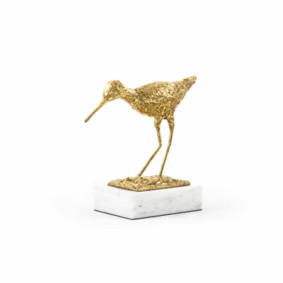 A miniature gold sculpture of a bird perched on a marble base, capturing attention with its detailed design.