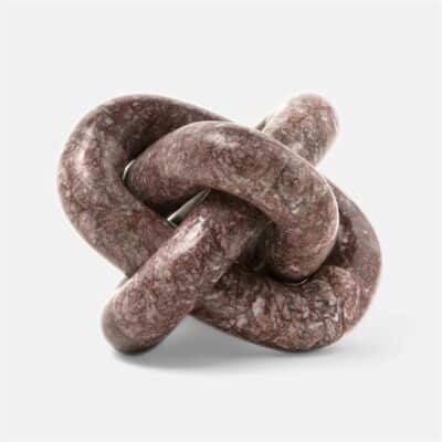 Tallis object in maroon stone, knotted with white string, set against a white background.