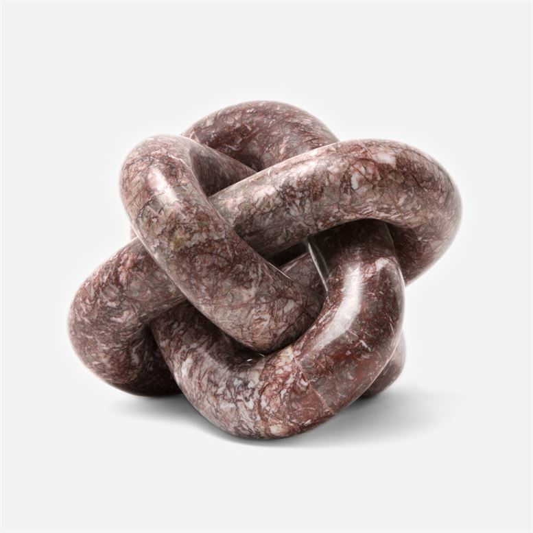 A large circular red stone knot with a shiny marble-like texture showcasing the intricate detail of its circular form and the knot
