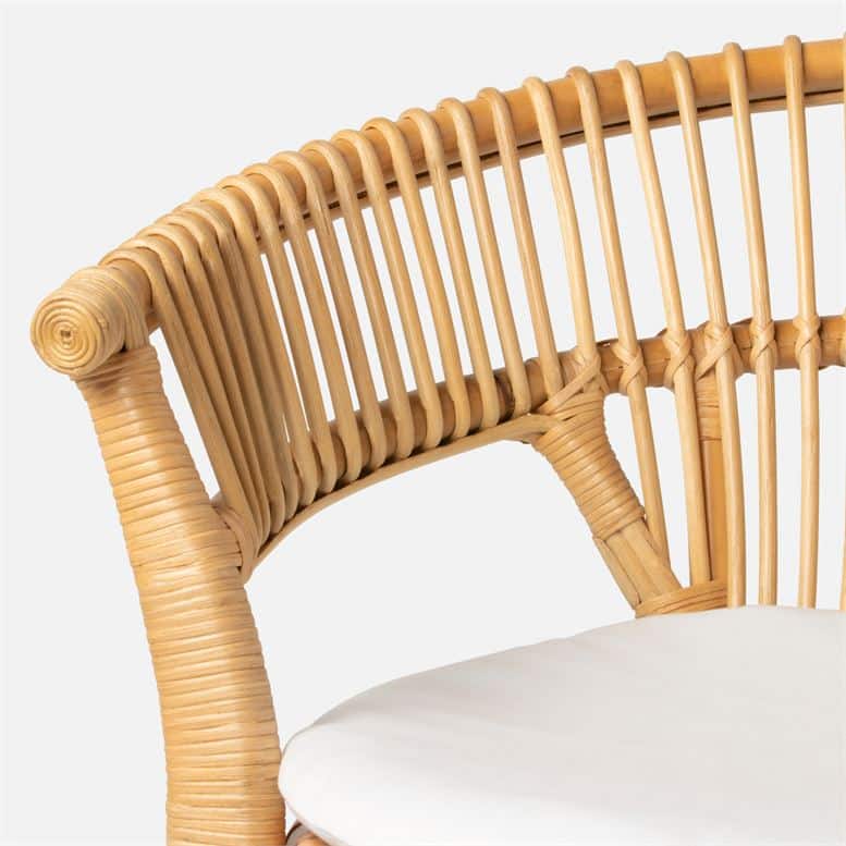 This is a wicker dining chair with a barrel back design featuring a bamboo frame and a round seat cushion The chair