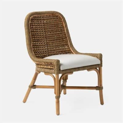 Wicker dining chair featuring double braided water hyacinth woven over a rattan frame with rounded corners sloping sides and X-stretcher design topped