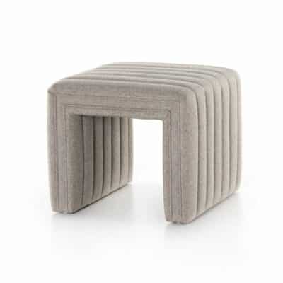 Modern ottoman with a herringbone pattern fabric upholstery, set against a white background.