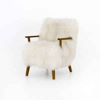 Cream Flokati Arm Chair with sculpted arms of drifted oak, set against a white background.