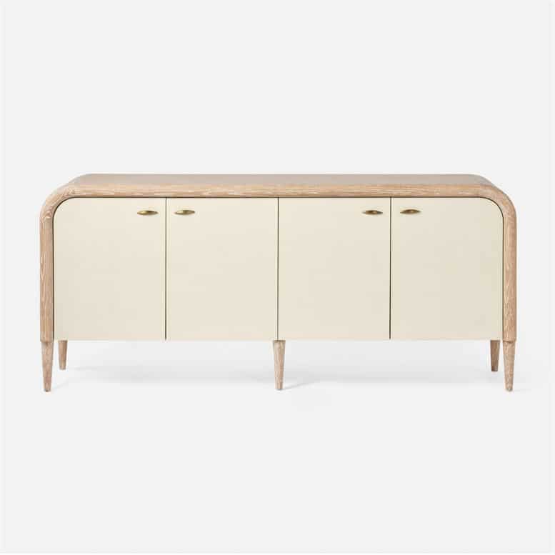 Beige wooden buffet with a curved front and three doors each featuring two handles It has a vintage faux shagreen top with