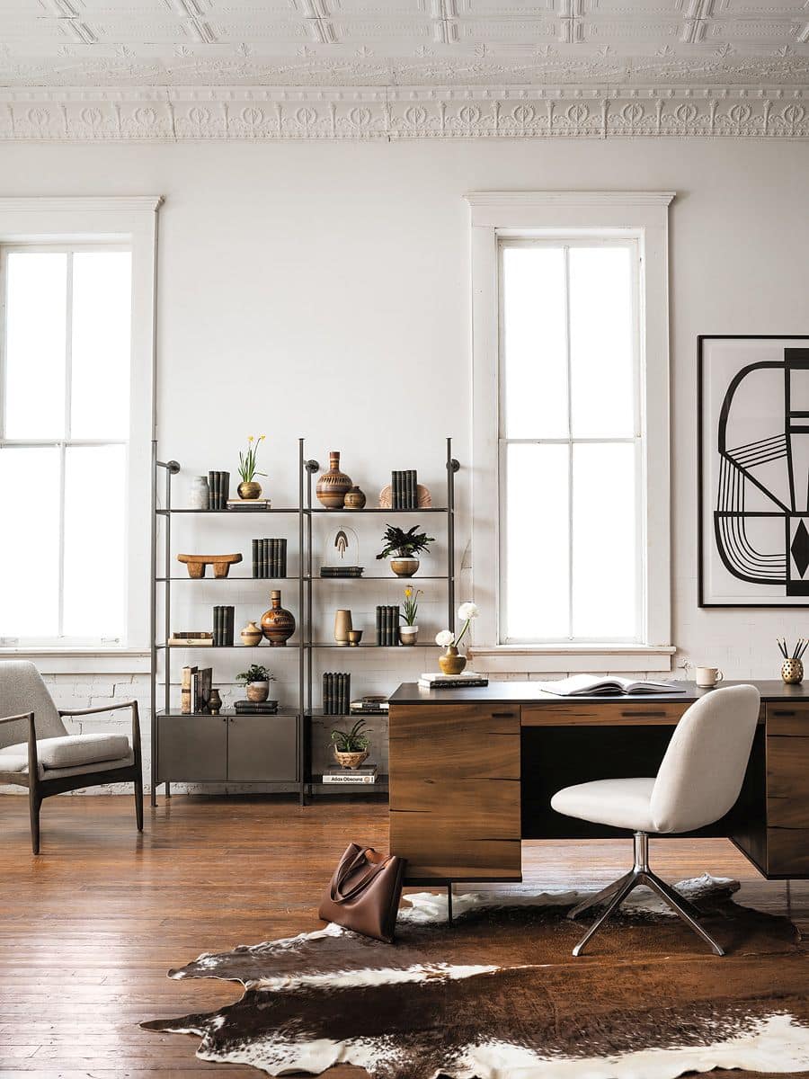 A modern living room setting showcasing a cozy corner with a stylish light camel upholstered Bradley Lounge Arm Chair positioned next to