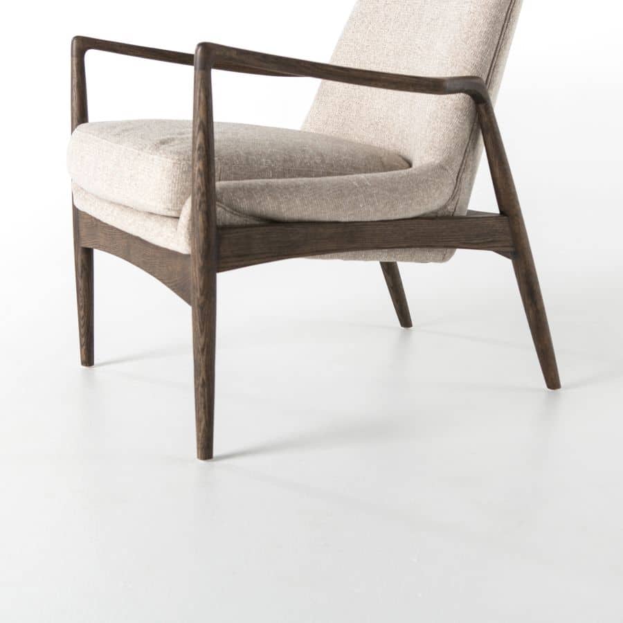 Modern light camel upholstered arm chair with a warm nettlewood oak frame, set against a white background.
