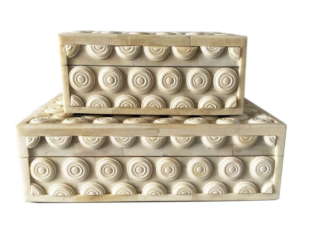 A set of two decorative bone boxes featuring a grommet design, with one larger and one smaller, displayed against a white background.