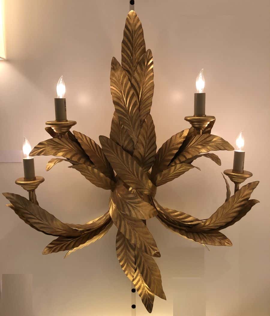 Gold wall sconce with six lights and laurel leaf design.