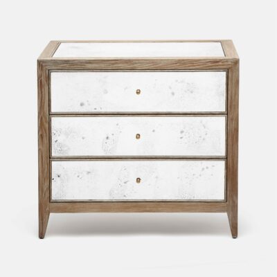 A large wooden nightstand with three drawers finished in silverleaf and antiqued mirror effect with a white marble-like texture on top The
