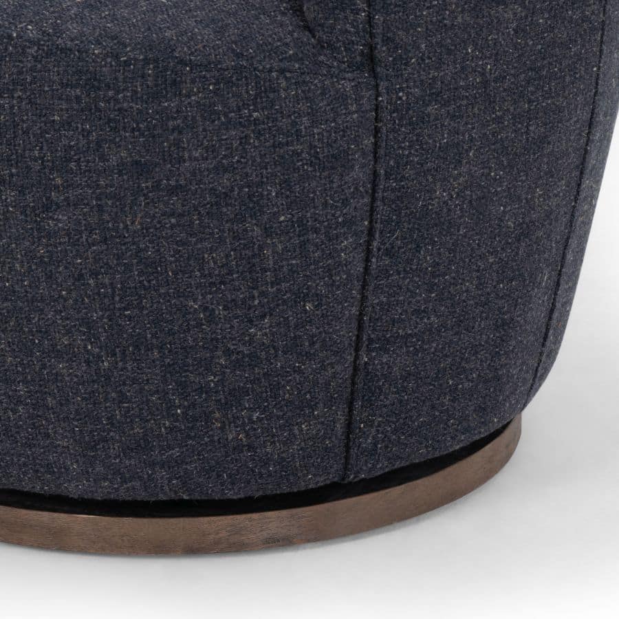 A petite chair with a blue grey fabric upholstery and a brown wooden base.