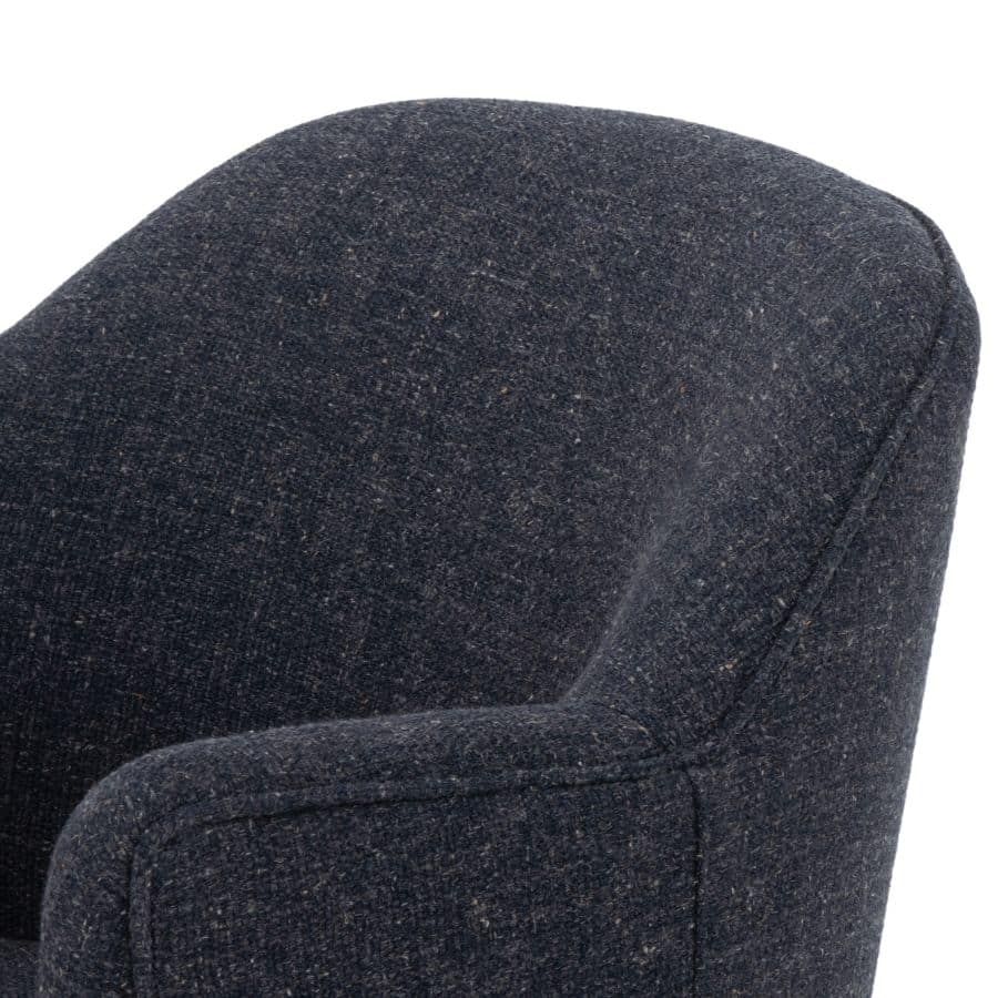 A petite swivel chair with a blue grey upholstery and natural parawood base, presented in a close-up view.