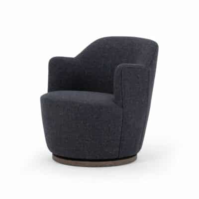 A small, modern chair with a blue grey upholstery and natural wood base, showcasing its textured fabric design.