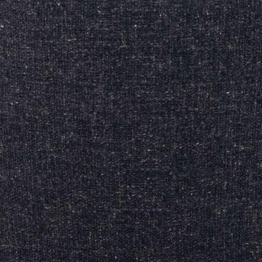 A small, plush swivel chair with a blue grey fabric upholstery and a natural parawood base.