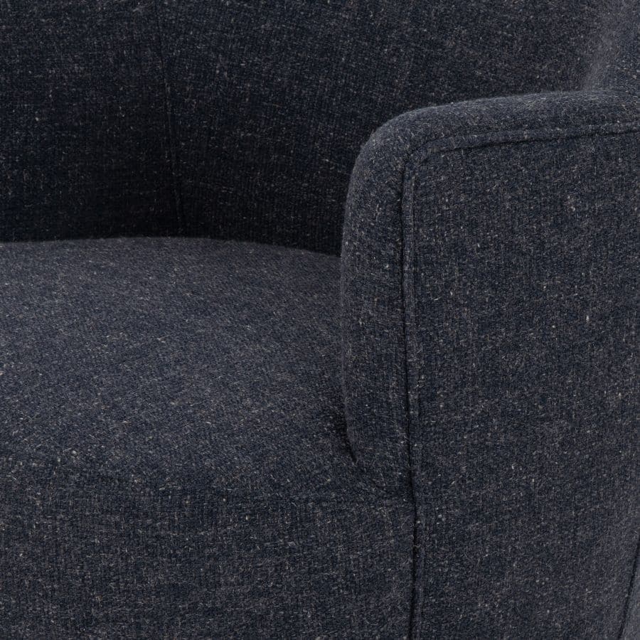 The image depicts a cozy blue grey petite swivel chair, crafted from natural parawood and upholstered in a luxurious boucle fabric.