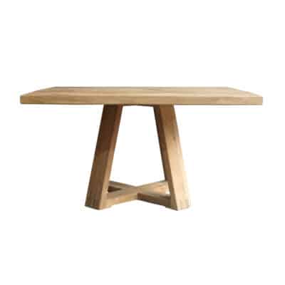A square dining table made from lightened natural teak wood featuring an X-shaped base and slats on top for a rustic appearance