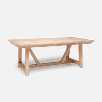 A white washed teak farm style dining table, featuring a parquet top design and sturdy wooden frame.