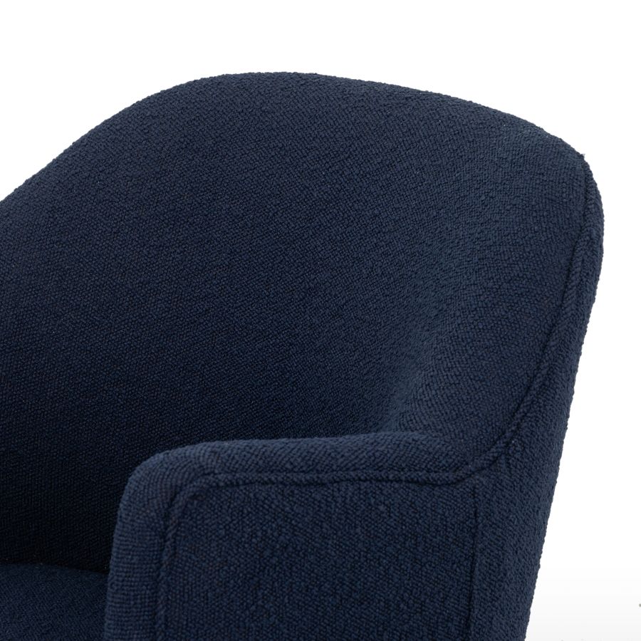 The image displays two identical blue upholstered chairs positioned side by side Each chair has a curved armrest and is situated on