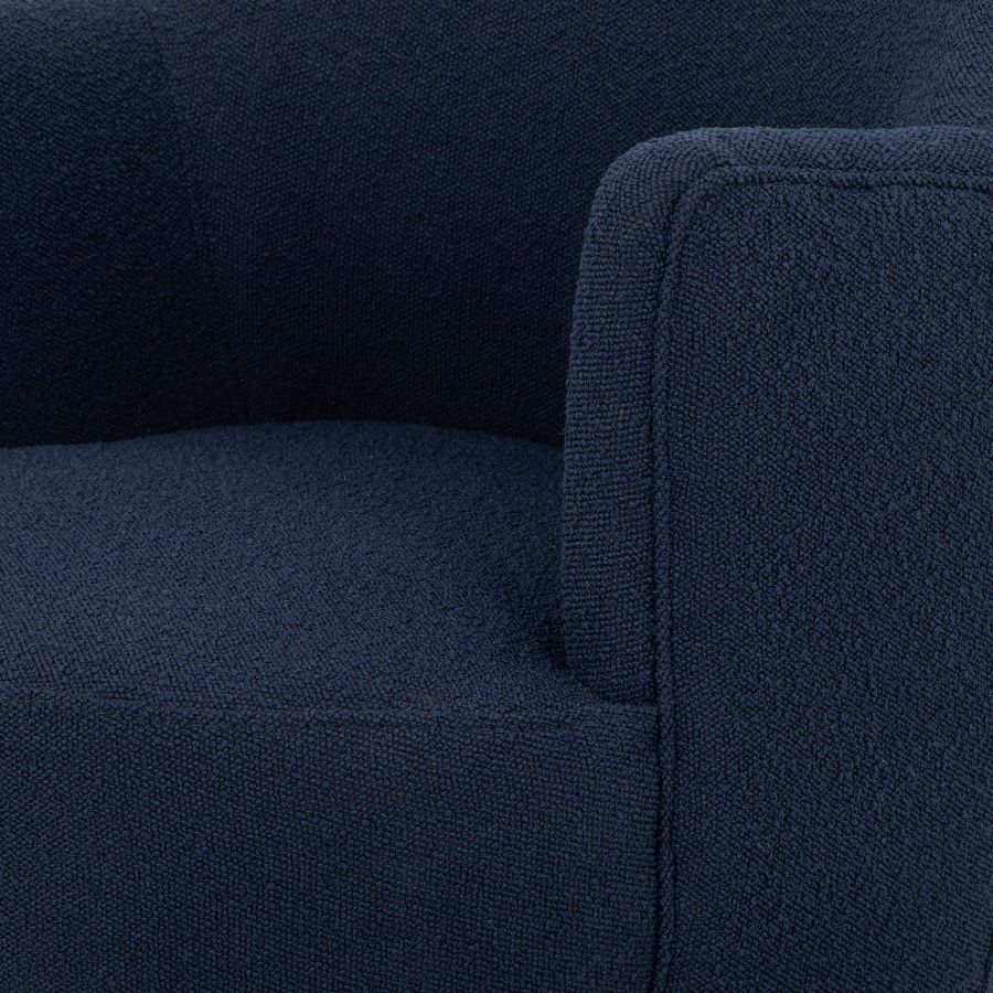 A blue upholstered petite swivel chair with a natural wood base, showcasing its fabric texture and design.
