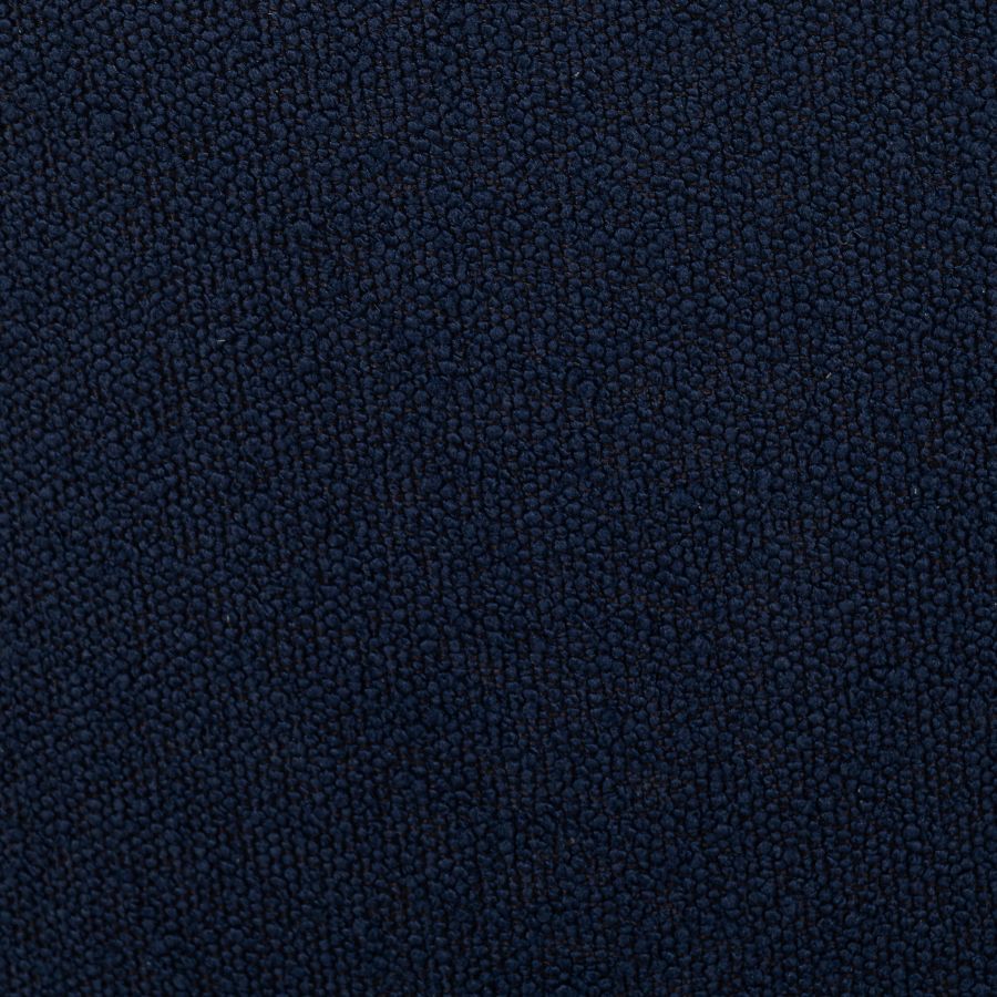 A photograph of a dark blue upholstered chair with a swivel base showcasing its fabric texture and the circular design on the