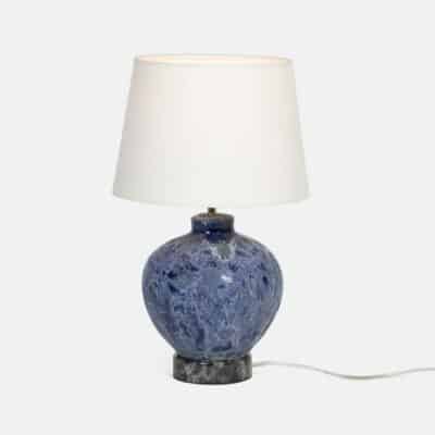 Vintage inspired table lamp with blue reactive ceramic finish.