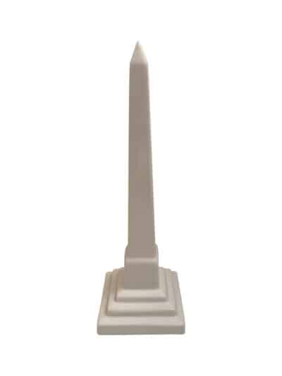 White ceramic obelisk against white background