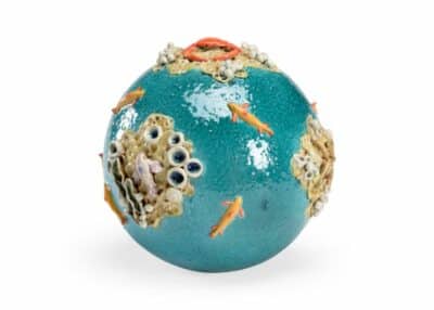 Hand sculpted and hand painted ceramic sea sphere showcasing a vibrant turquoise color with intricate details such as marine life coral formations