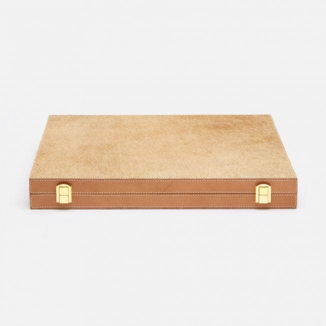 A beige leather backgammon set featuring an aged camel hair hide cover and bone and horn pieces.