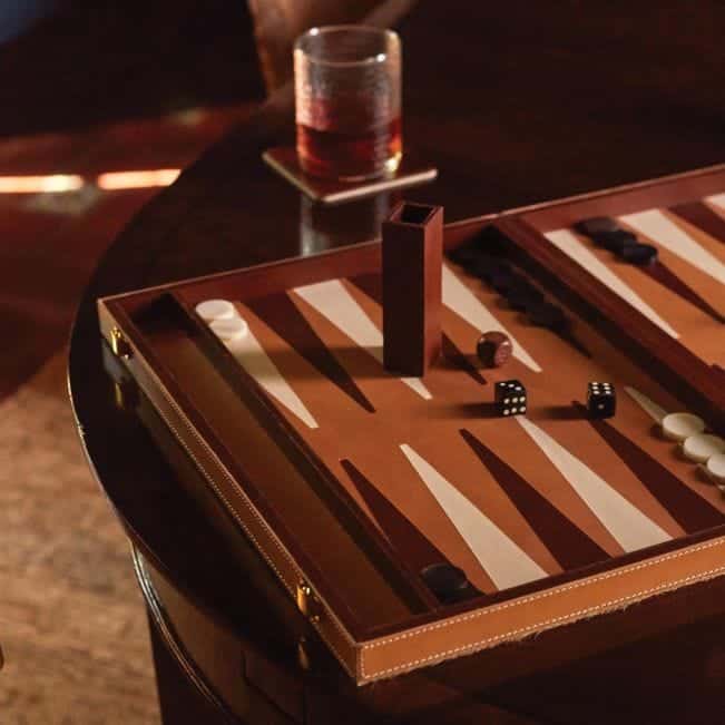 Leather and Hide Backgammon Set with wooden board, bone dice, and horn pieces on an aged camel hair hide cover.