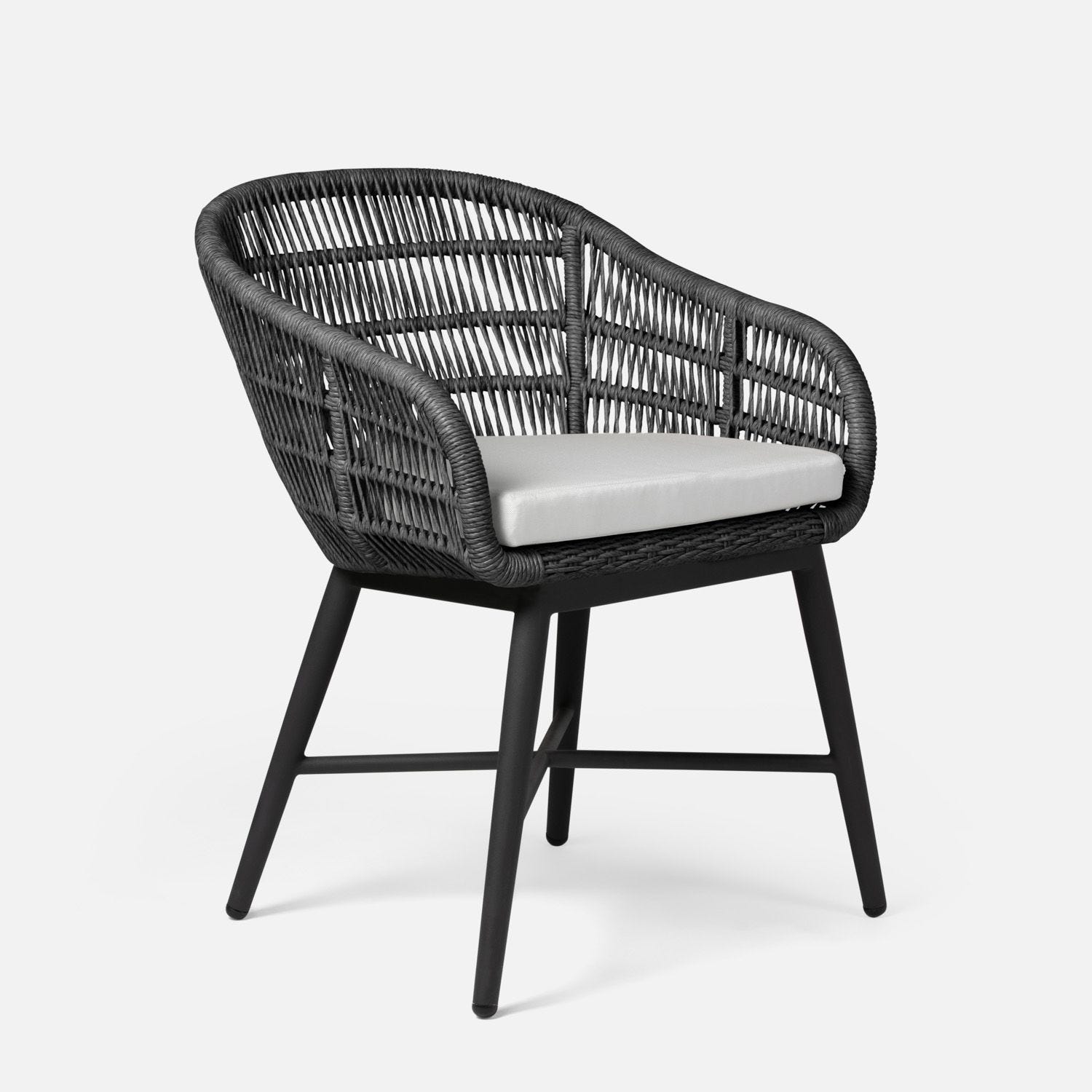 Black wicker chair with grey cushion on white background.