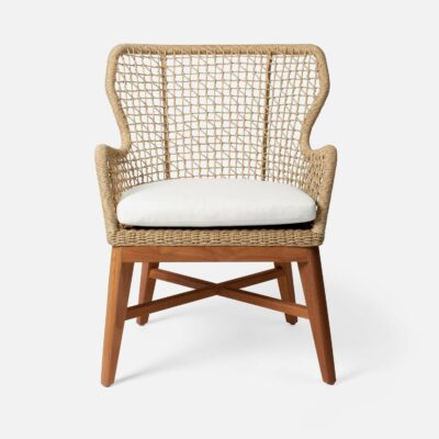 Modern outdoor wingback chair with natural twisted faux wicker, teak frame, and white cushions.