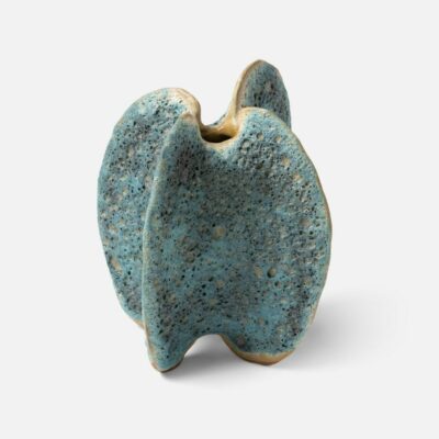 Textured ceramic blue vase, showcasing its unique surface texture and vibrant color.