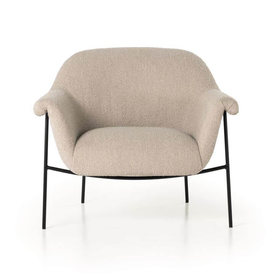 The Kent Mid-Century Style Boucle Chair in Sand, featuring a plush fabric upholstery and sturdy black metal frame.