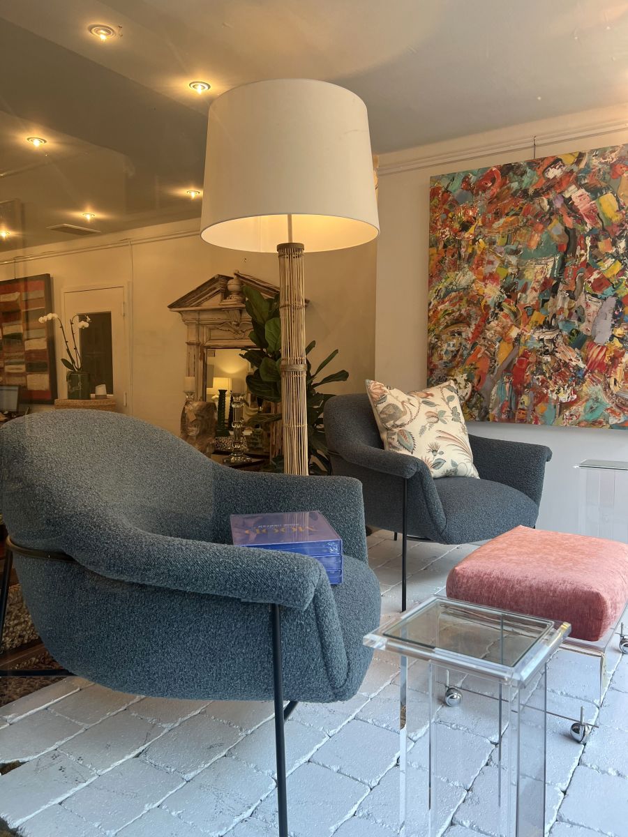 Blue boucle chair with black iron base, mid-century style.