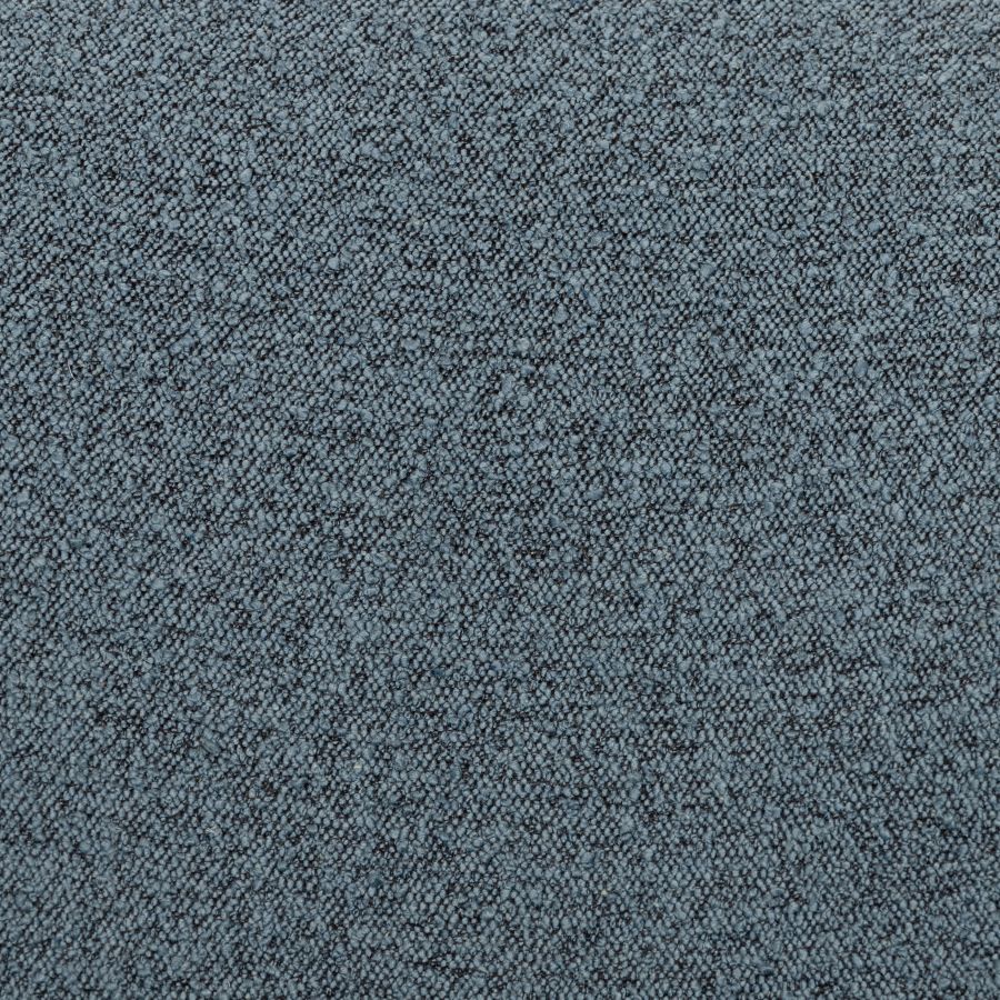 A close-up of a blue and white patterned fabric chair with a black iron base, showcasing its design and texture.