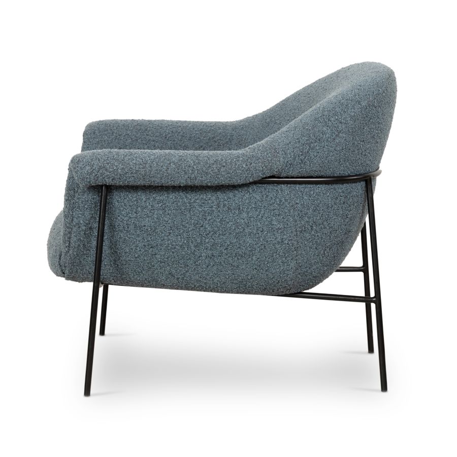 Modern mid-century style boucle chair with black metal legs, available in sky blue or sand fabric.
