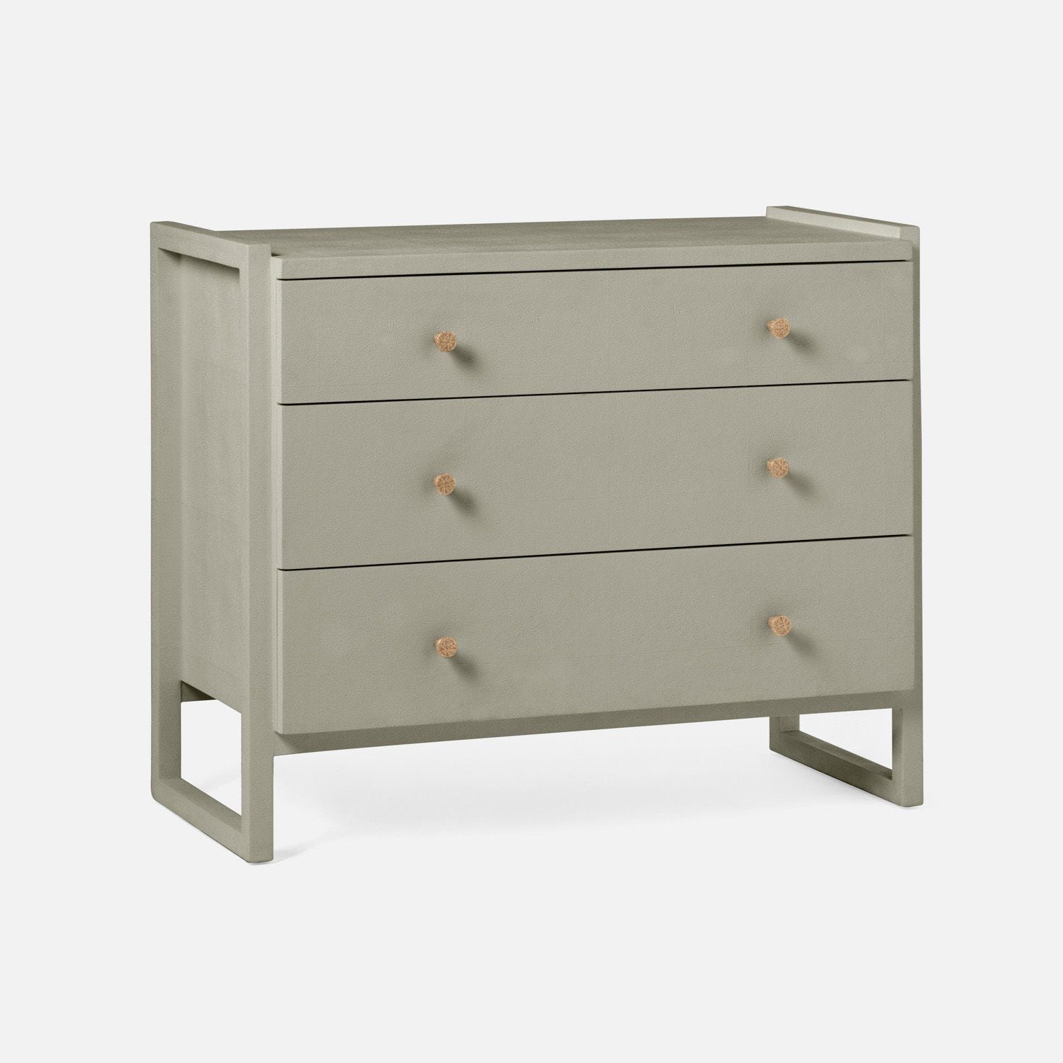 Small, modern dresser with three drawers, featuring a sleek design in castor gray or French gray finish, available in other styles.