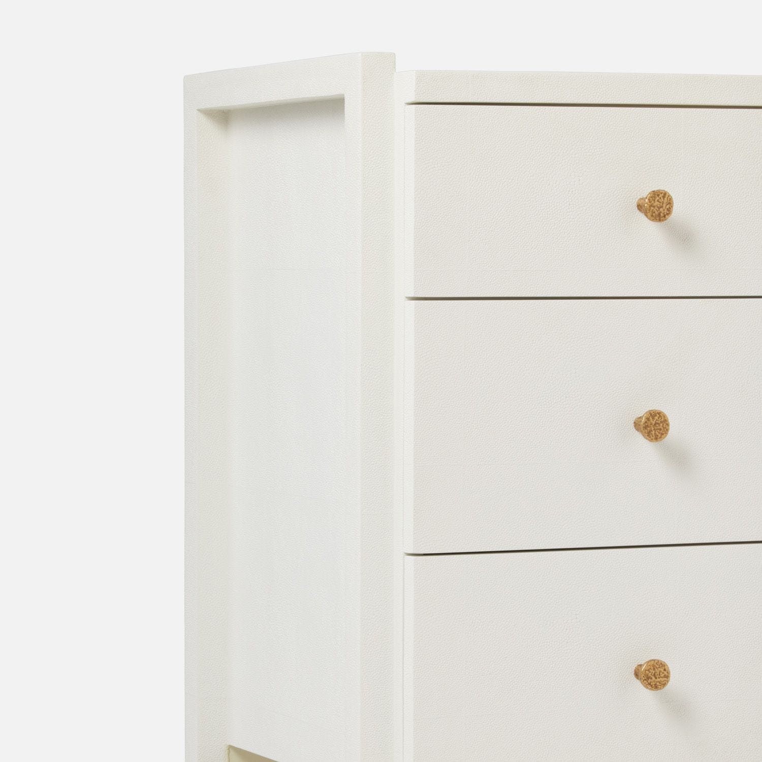 A white small three drawer dresser with a modern design, featuring a faux shagreen finish.