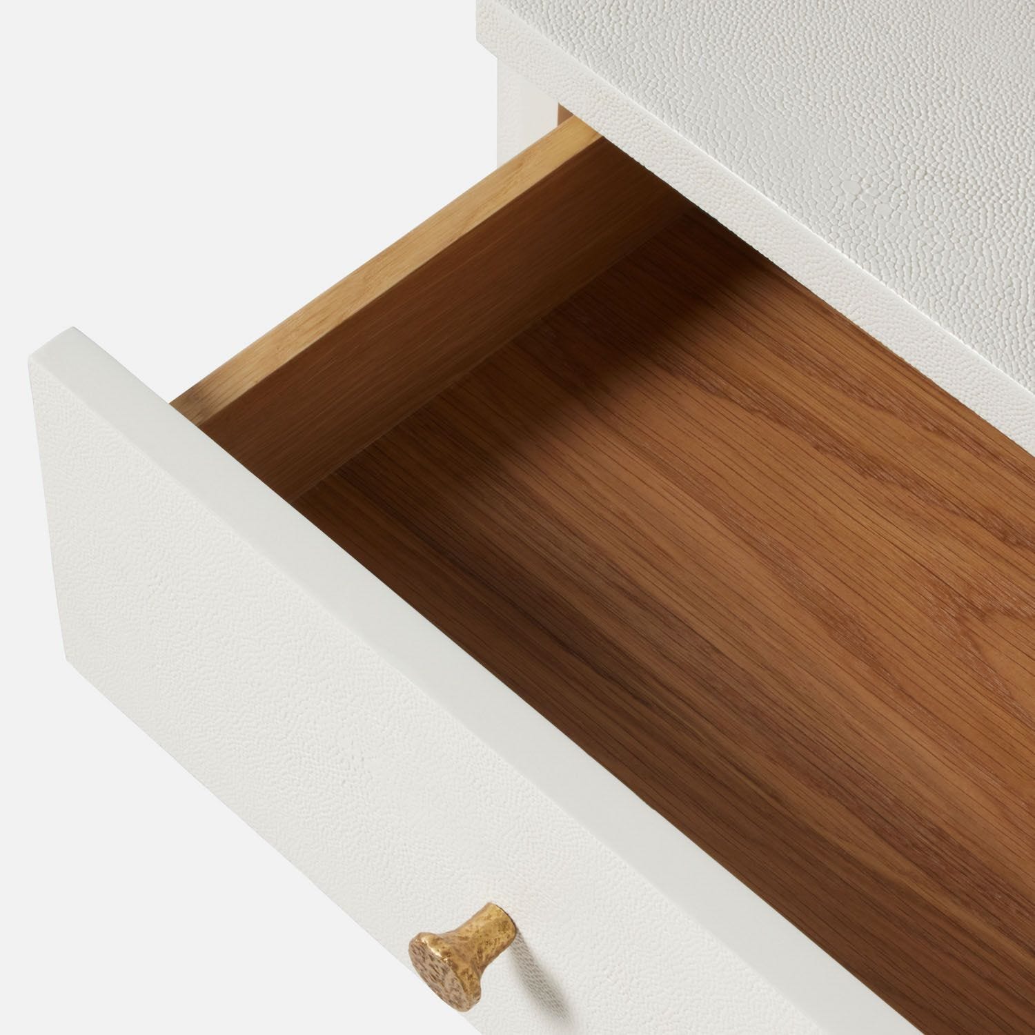 White desk drawer with wooden interior, showcasing a single brass handle.