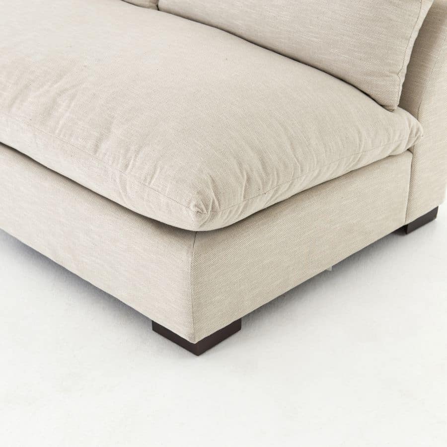 Modern sectional sofa in neutral fabric, featuring an armless design with espresso legs.