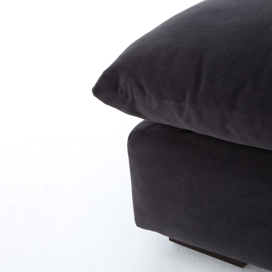 Black sectional sofa with a modern design featuring an armless style and high performance fabric upholstery The sofa is presented in a