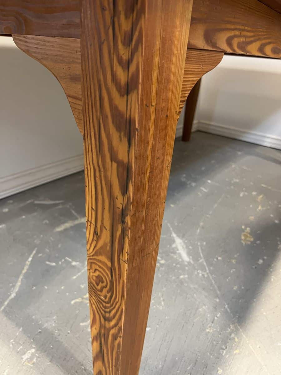 Custom French farm style dining table in reclaimed pondersa pine, showcasing distressed fruitwood finish and exquisite grain details.