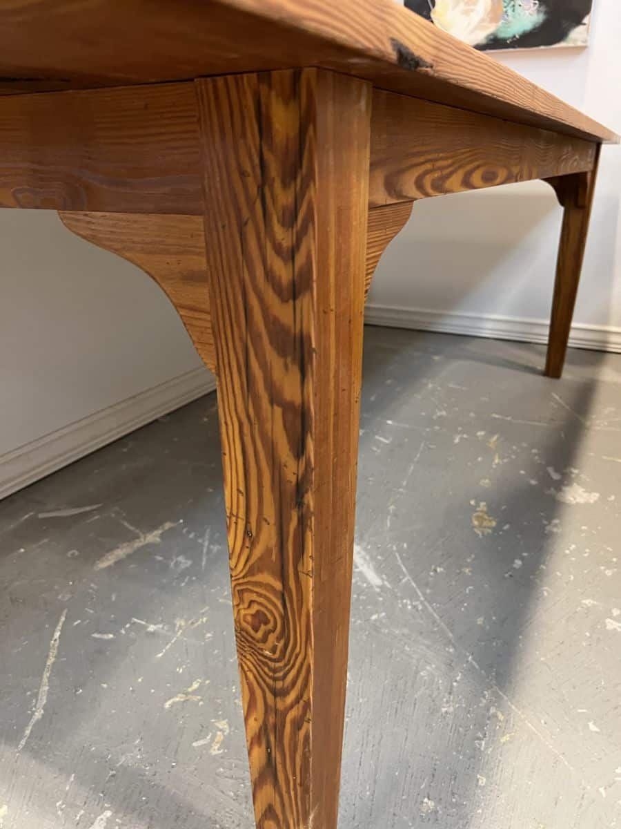 Custom French Farm Style Dining Table featuring reclaimed pondersa pine boards and a distressed fruitwood finish showcasing exquisite grain details in a